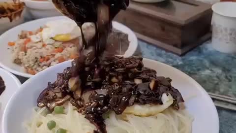 Eating delicious black bean noodles