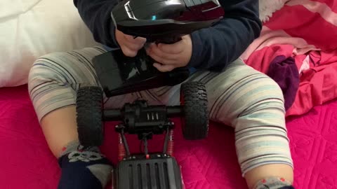 The baby learns to control remote control car