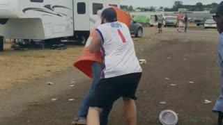Guy with 1 jersey tackles pushes guy with orange traffic cone over him