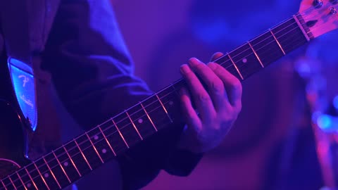 Guitarist playing an electric guitar on stage