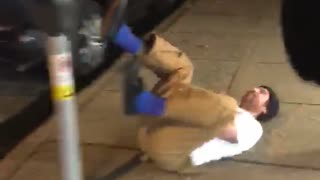 Guy tries to jump parking meter on street and falls down