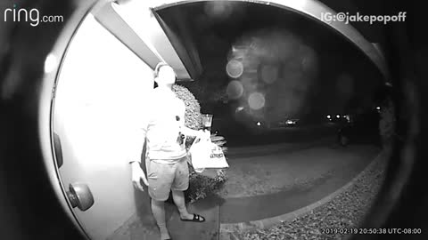 Front door security camera, guy holds cup of bud light beer to unlock door and drops beer