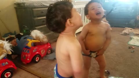 Super cute toddler boy reacts to putting his bare tummy against the mirror, but then...