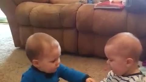 Twin babies have adorable fight