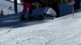 Guy white pants hanging on ski lift