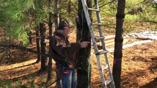 Using a water level to set treehouse brackets by Bigfoot Treehouses