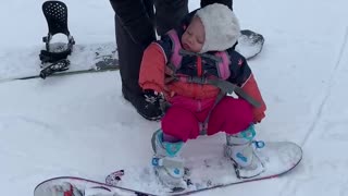 Baby isn't interesting in snowboarding - would rather nap instead!