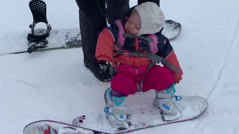 Baby isn't interesting in snowboarding - would rather nap instead!