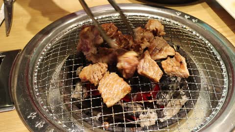 Korean Barbecue 'Galbi' is being cut with a pair of scissors.