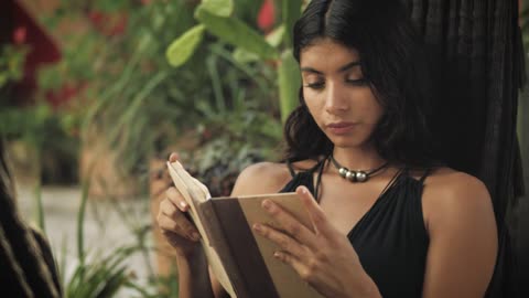 A woman reading on a hammock