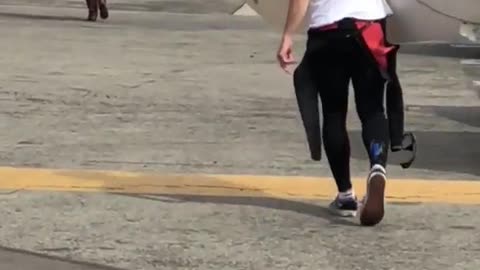 Guy asks white board man in parking lot which way to beach