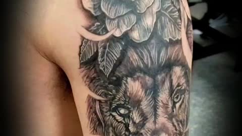 Lion with floral tattoo