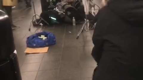 Little boy does the floss dance and the splits in subway station