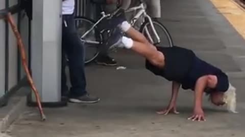 Blonde man black shirt hand stand