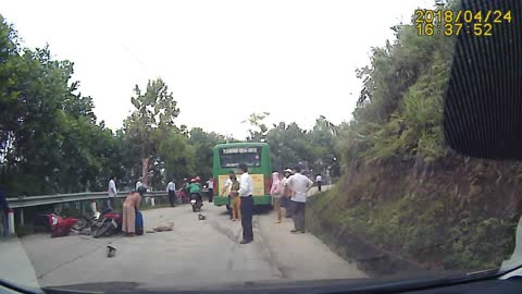 Colliding Motorcyclists Narrowly Avoid Bus