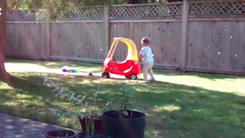 Andre pushing toy car