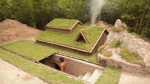 Building underground hut with grass roof & fireplace with clay