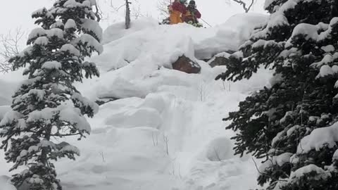 Guy skis down steep mountain and tumbles down, friends laugh