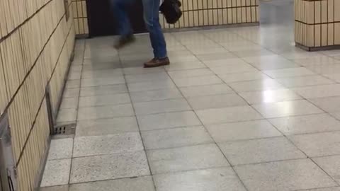 Old guy in suit kicks leg up at wall