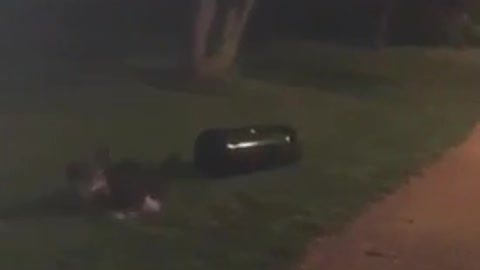 Guy running and knocking down trash can falls