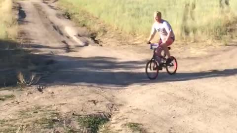 Guy red bike dirt ramp jump fail flies into lake water