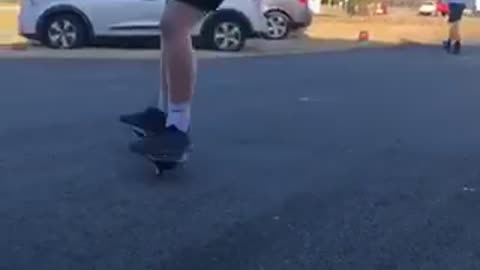 Backwards hat short shorts kid rides ripstick driveway