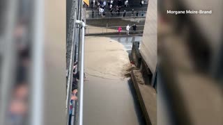 Swiss residents watch floodwaters gushing down streets