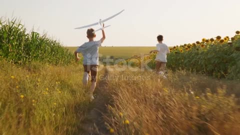 Children playing wd Dog in Field