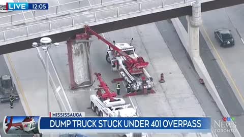 HIGHWAY 401 TRAFFIC CHAOS:DUMP TRUCK CONTAINERSTUCK UNDER OVERPASS