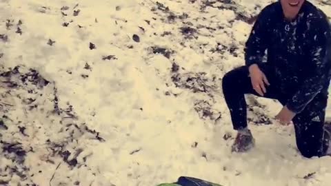 Beanie guy rides boogie board off snow ramp and faceplants