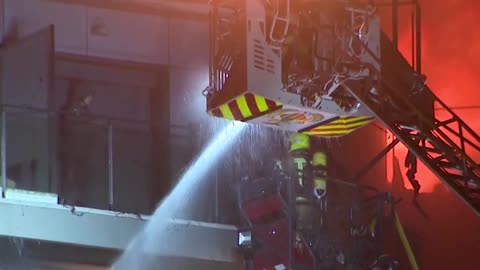 Firefighters rescue people from burning building in Spain