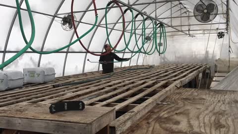 Overhead hose carriage / trolley for greenhouse watering