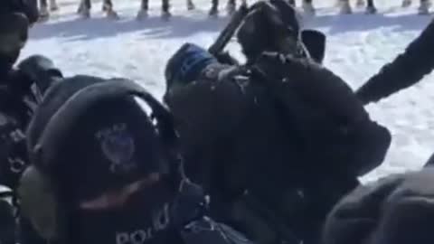 Ottawa police using butt end of tear canister rifle to beat protester