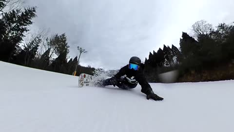 Professional Snowboarder Was Going Smoothly With His Side Body On Snow