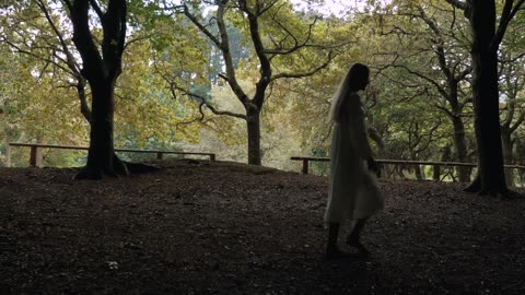 A blonde girl just barefoot walking in the forest