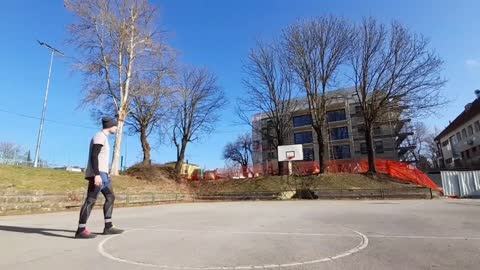 Guy Lands a 360 Heel and Spin Half Court Trick Shot