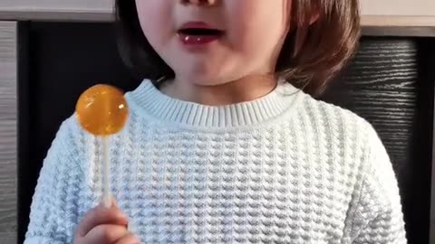 Super cute baby eating lollipops