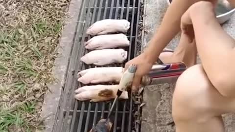 Man cooks pork trotters over longkang grille in MacPherson