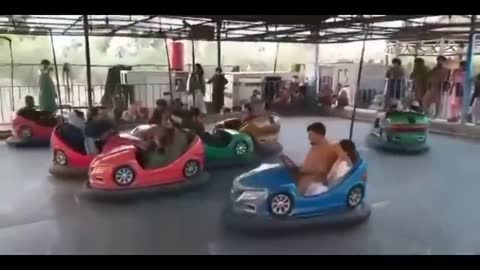 Taliban Celebrating on Kids Rides.