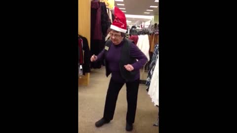 Woman busts a move in a singing santa hat