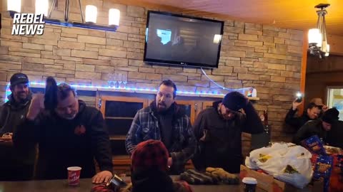 Truckers say a prayer before continuing to hold their blockade