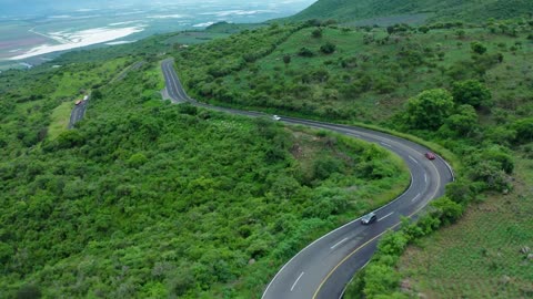 Curvy road on a tree covered hill