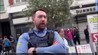 Transgender protestor with a board in Grafton St hassled by a Garda (Gemma O'Doherty) 22-05-23