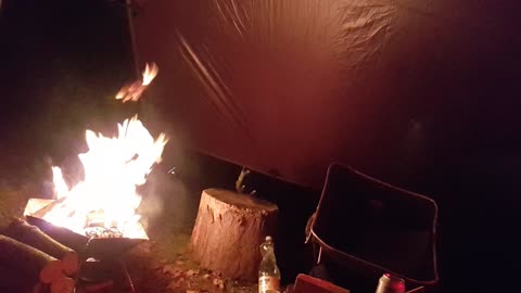 Portable firepit under a tarp in the rain. SEP 2022