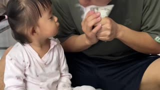 Dad accidentally sprays milk on daughter's face