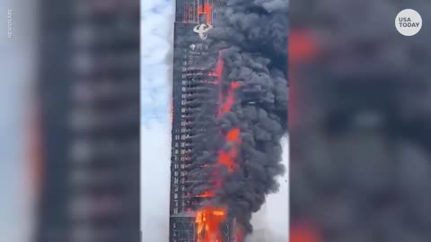 Flames engulf skyscraper in China