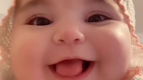 Cute baby playing games in mobile phone
