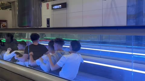 Boys Row Down Moving Sidewalk