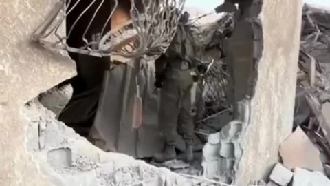 Israelis mockingly ring the bell of a Palestinian home destroyed by the occupation forces