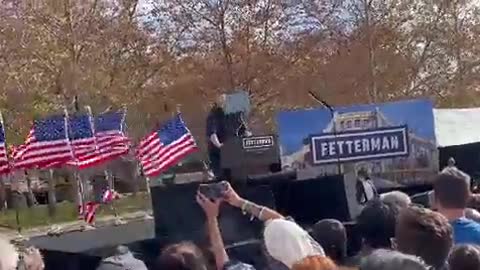 Right when Fetterman introduces Obama as a "sedition free" president, all the American flags fall over.